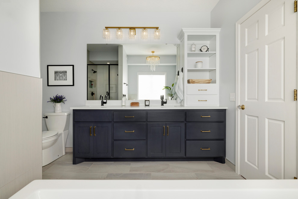 Design ideas for a large modern ensuite bathroom in Minneapolis with flat-panel cabinets, black cabinets, a freestanding bath, a corner shower, a two-piece toilet, beige tiles, ceramic tiles, grey walls, porcelain flooring, a built-in sink, tiled worktops, grey floors, a hinged door, white worktops, a wall niche, double sinks and a built in vanity unit.