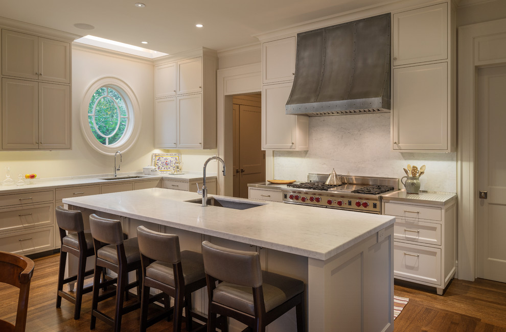 Inspiration for a traditional l-shaped eat-in kitchen in San Francisco with an undermount sink, recessed-panel cabinets, white cabinets and white splashback.