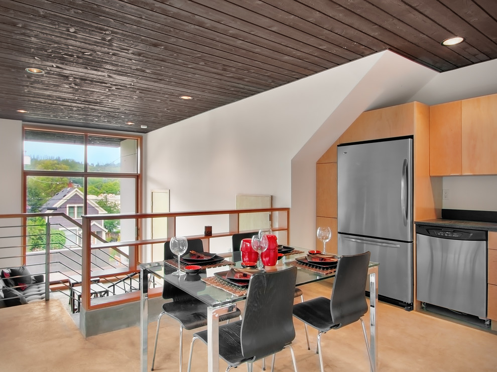 Photo of a modern kitchen/dining combo in Seattle with white walls.