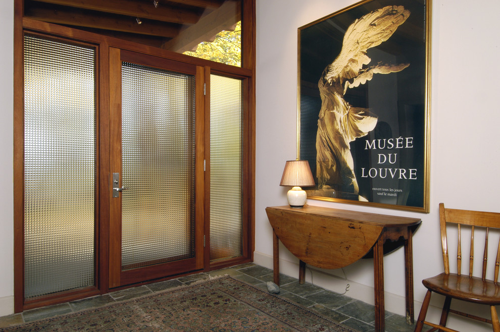Photo of a contemporary entryway in Boston with white walls, a single front door and a glass front door.