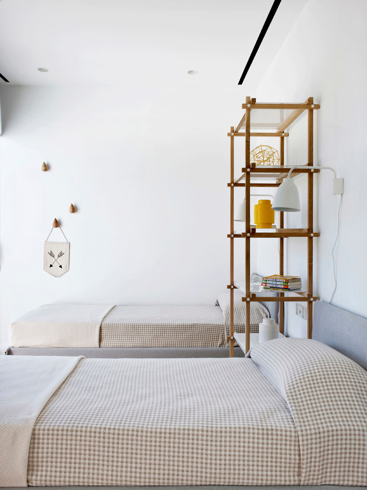 Mid-sized scandinavian gender-neutral kids' room in Moscow with white walls and medium hardwood floors.