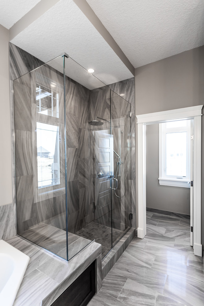 Transitional master bathroom in Edmonton with beige walls, ceramic floors, an undermount sink, shaker cabinets, dark wood cabinets, granite benchtops, a drop-in tub, a corner shower, gray tile and ceramic tile.