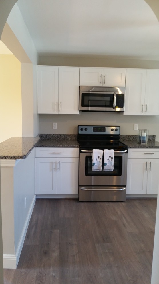 Mid-sized transitional l-shaped eat-in kitchen photo in Providence with a single-bowl sink, shaker cabinets, white cabinets, granite countertops, stainless steel appliances and a peninsula