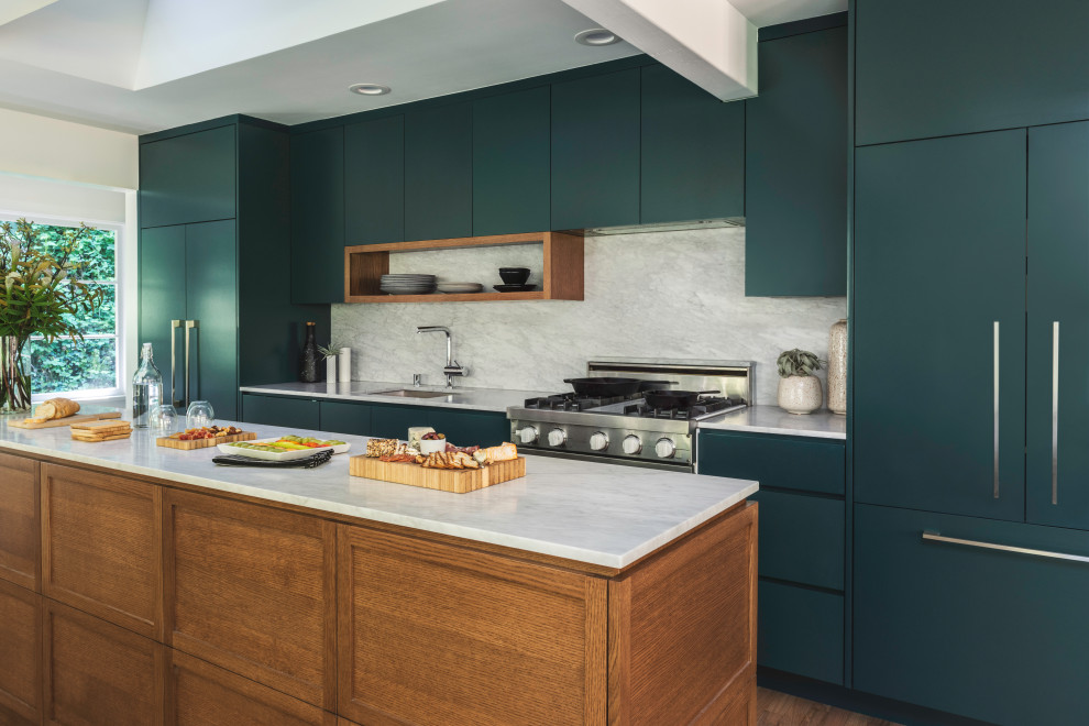 Photo of a contemporary galley kitchen in Seattle with an undermount sink, flat-panel cabinets, turquoise cabinets, grey splashback, panelled appliances, medium hardwood floors, with island, brown floor and white benchtop.