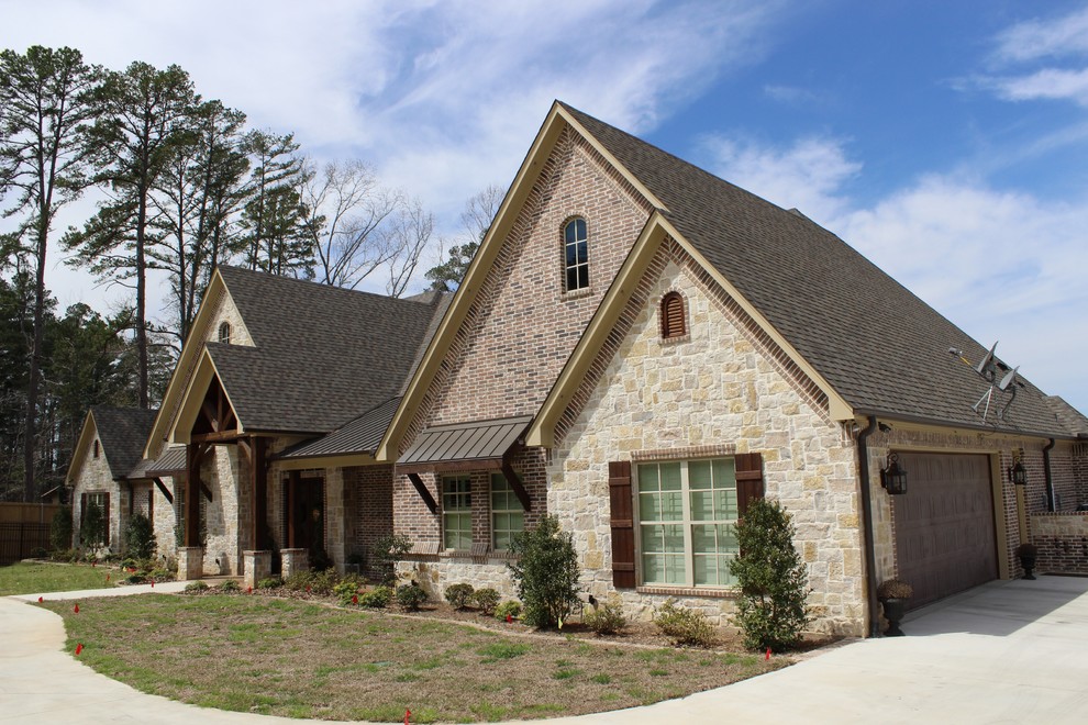 This is an example of an expansive country one-storey exterior in Austin with mixed siding.