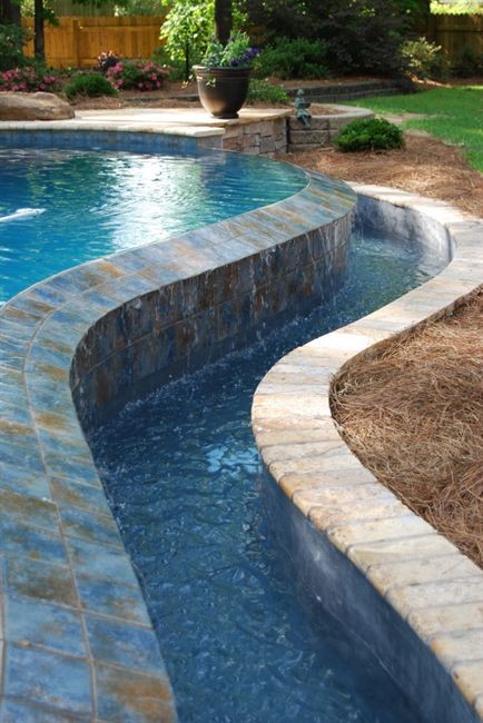 Mid-sized backyard stone and rectangular pool photo