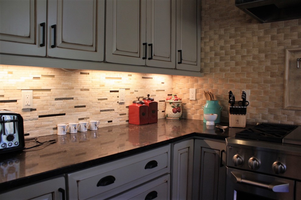 Huge mountain style l-shaped open concept kitchen photo with an undermount sink, quartz countertops, beige backsplash, stone tile backsplash, stainless steel appliances and an island