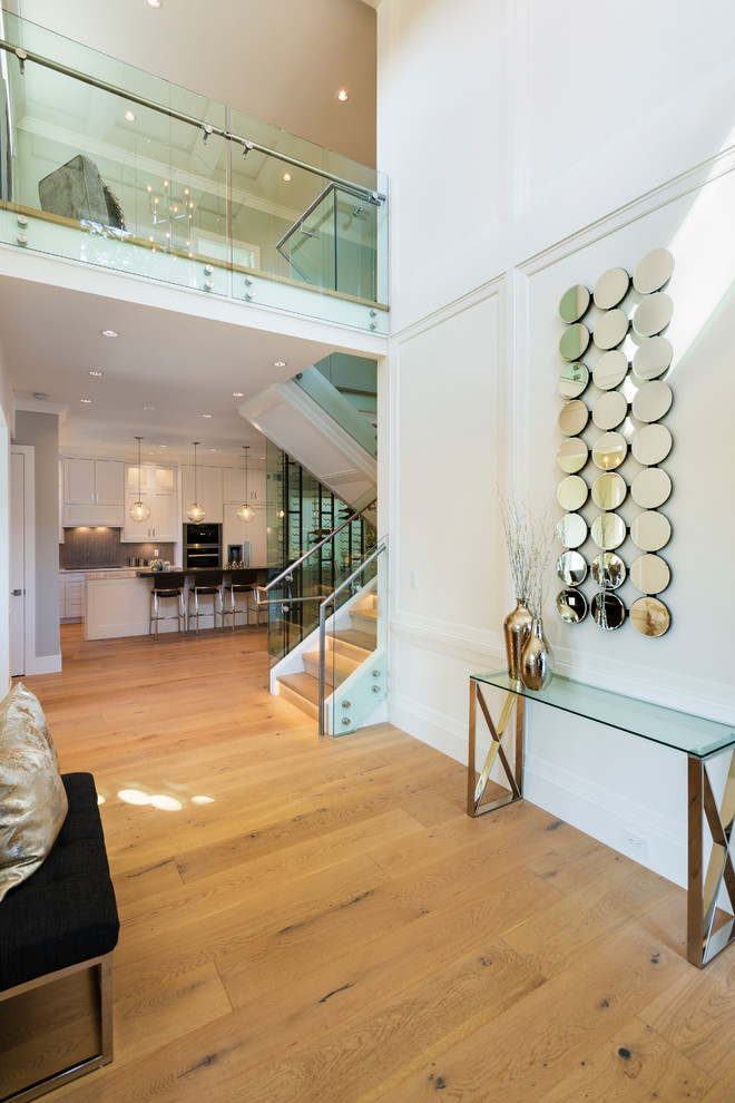 Foyer - mid-sized transitional light wood floor and beige floor foyer idea in Vancouver with white walls and a dark wood front door