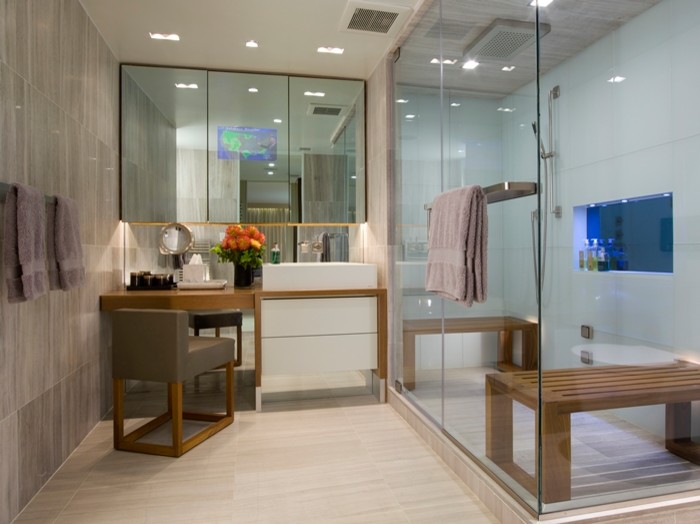 Photo of a mid-sized modern master bathroom in New York with flat-panel cabinets, yellow cabinets, a double shower, white tile, porcelain tile, brown walls, laminate floors, a vessel sink, wood benchtops, beige floor and a hinged shower door.