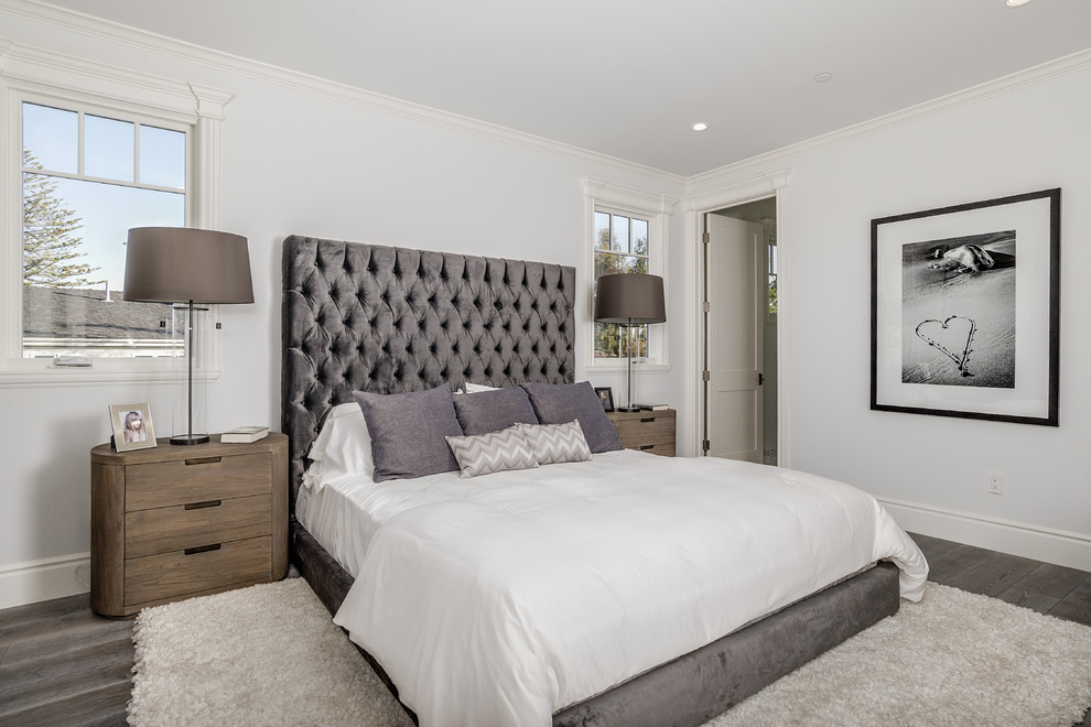 Transitional bedroom in Los Angeles with white walls, dark hardwood floors and brown floor.