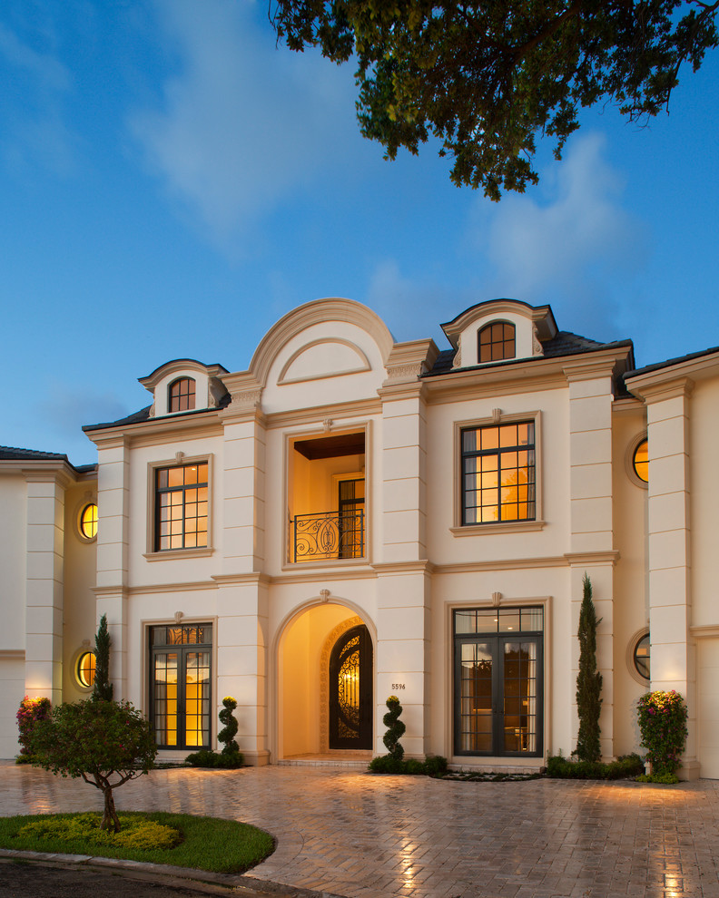 Design ideas for a traditional three-storey beige exterior in Miami.