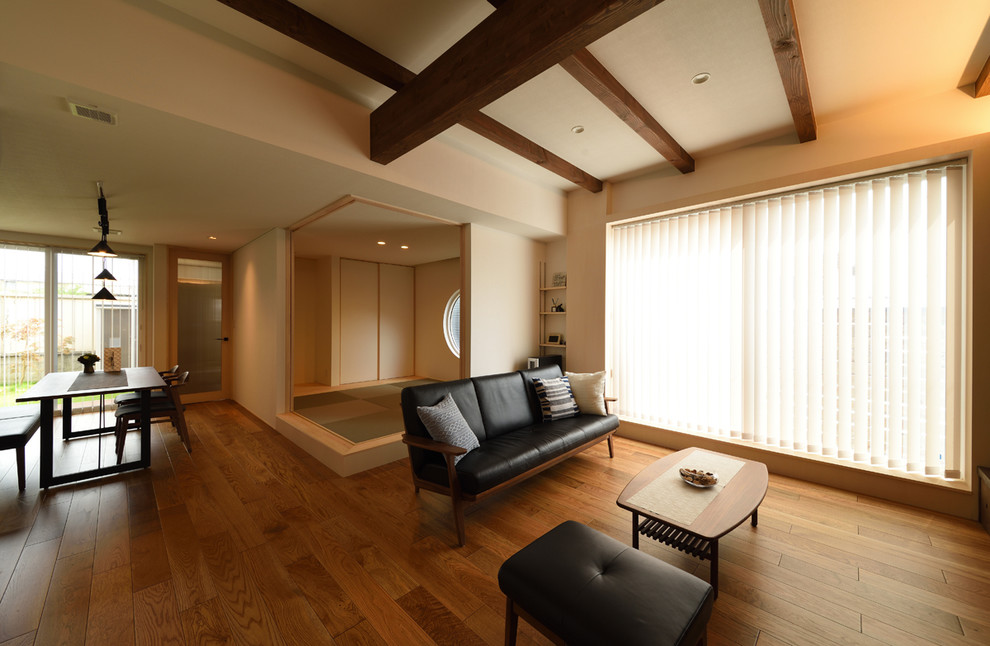 Asian open concept living room in Other with white walls, medium hardwood floors and brown floor.