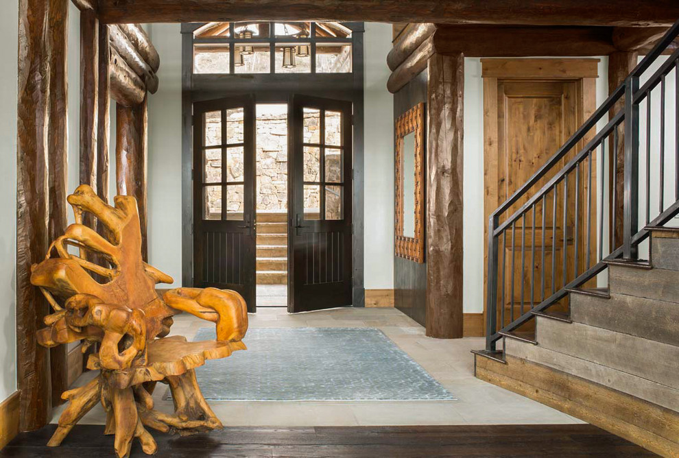 Design ideas for a country foyer in Denver with white walls, a double front door and a dark wood front door.