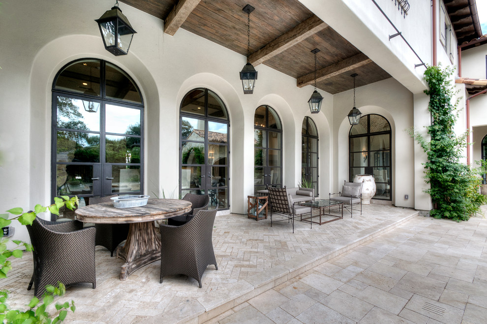 This is an example of a mediterranean verandah in Houston with a roof extension.