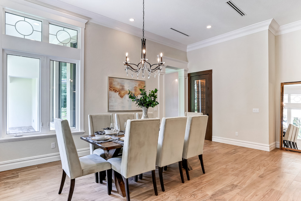 Inspiration for a large transitional open plan dining in Tampa with beige walls, light hardwood floors, no fireplace and brown floor.