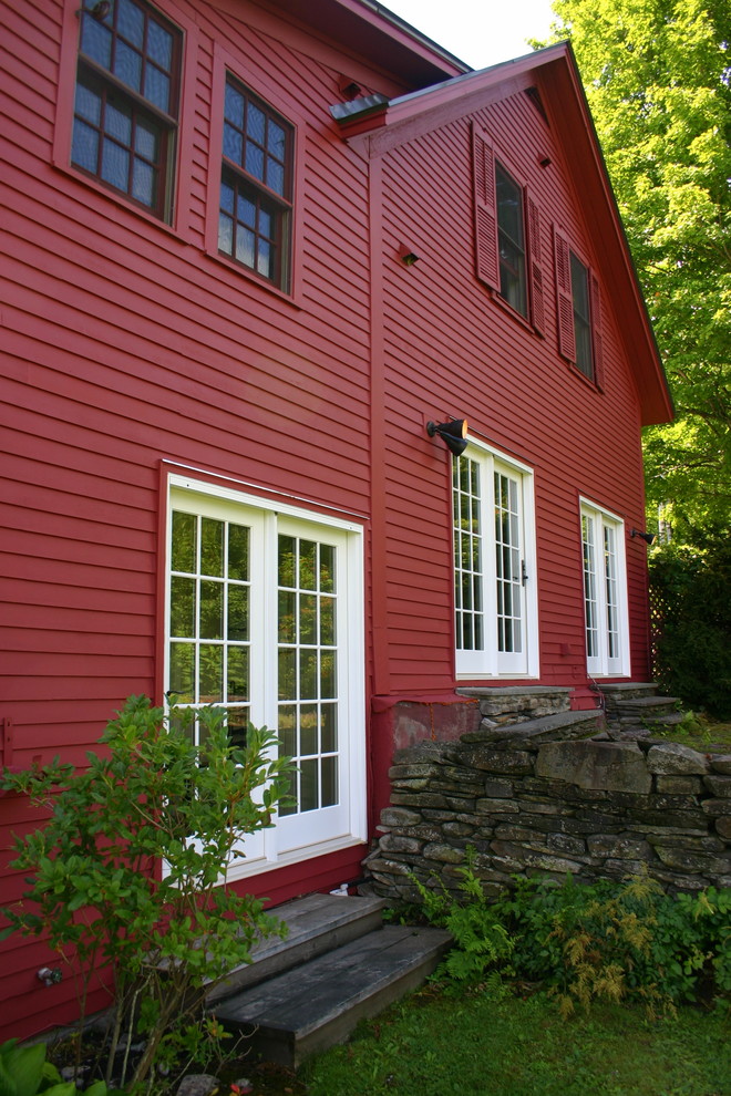 Inspiration for a country red exterior in Burlington with wood siding.
