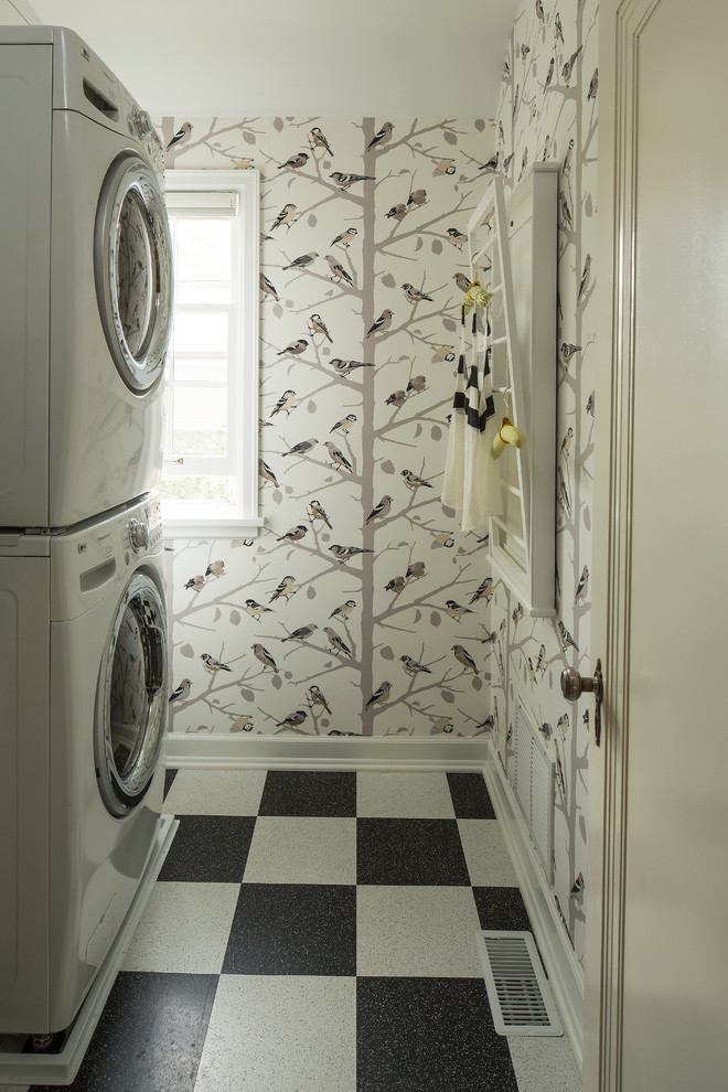 Inspiration for an eclectic laundry room in Minneapolis with a stacked washer and dryer and multi-coloured floor.