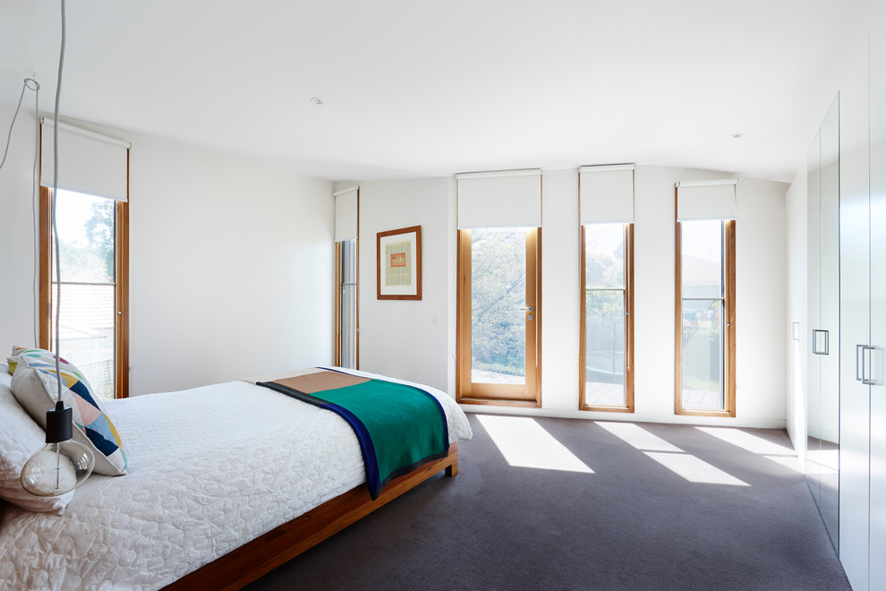 Design ideas for a mid-sized contemporary master bedroom in Melbourne with carpet and white walls.