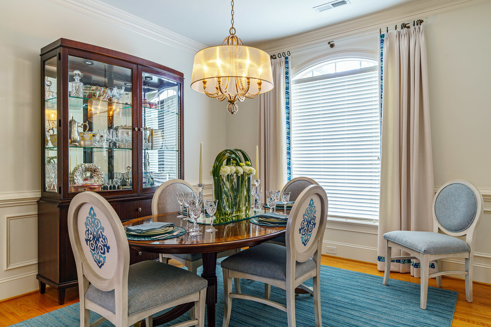 Mid-sized transitional medium tone wood floor and brown floor dining room photo with white walls and no fireplace