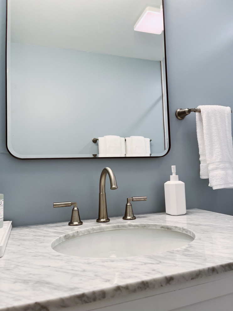 Small transitional kids' white tile and porcelain tile porcelain tile, white floor and single-sink alcove shower photo with shaker cabinets, white cabinets, a two-piece toilet, blue walls, an undermount sink, marble countertops, gray countertops and a freestanding vanity