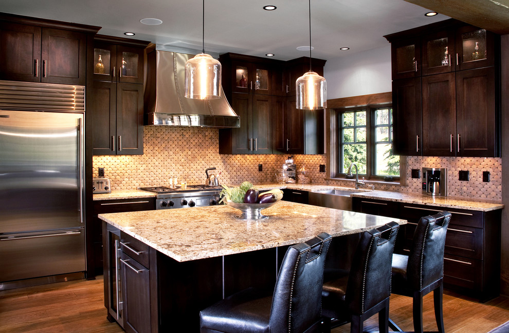 Photo of a traditional kitchen in Denver with dark wood cabinets and with island.