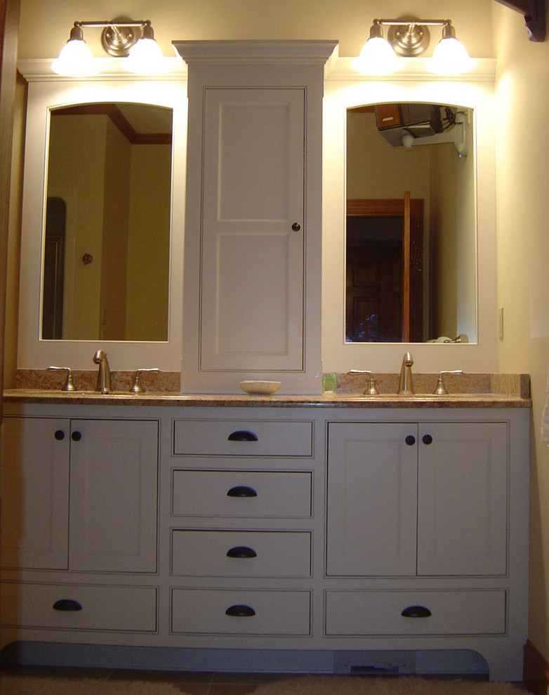 Photo of a country bathroom in Portland Maine with white cabinets and granite benchtops.