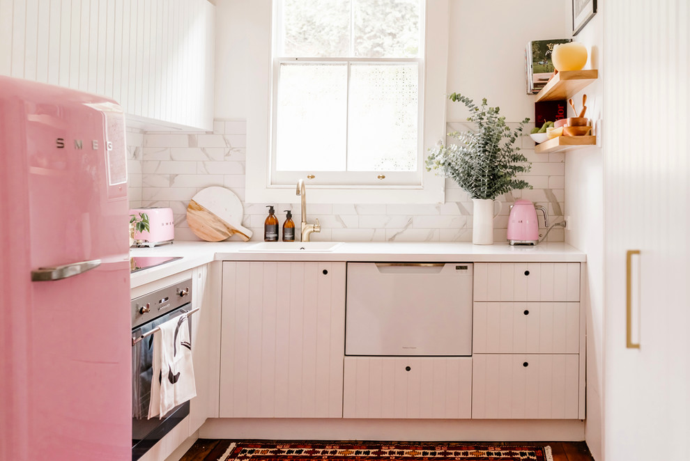 Design ideas for a small eclectic l-shaped separate kitchen in Napier-Hastings with a drop-in sink, white cabinets, laminate benchtops, white splashback, marble splashback, white appliances and no island.