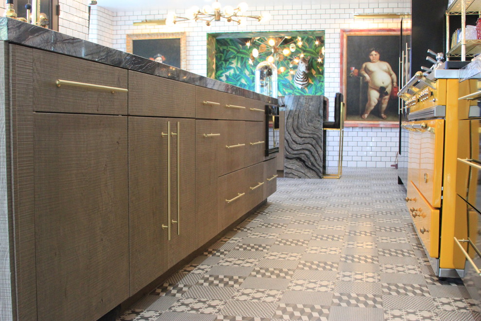Huge eclectic l-shaped ceramic tile enclosed kitchen photo in Orange County with an undermount sink, flat-panel cabinets, gray cabinets, marble countertops, white backsplash, subway tile backsplash, black appliances and an island
