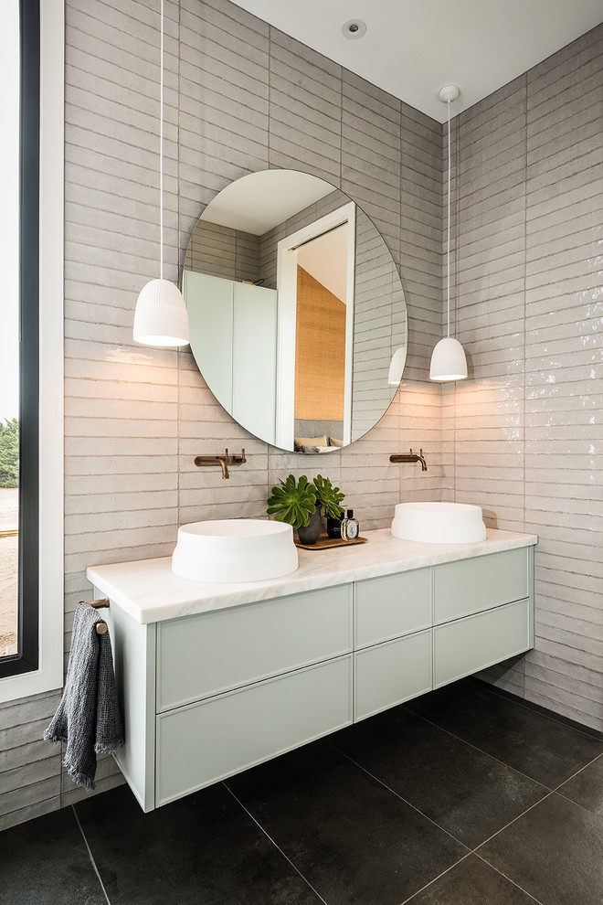 Photo of a mid-sized contemporary master bathroom in Melbourne with shaker cabinets, green cabinets, a freestanding tub, gray tile, ceramic tile, a vessel sink, marble benchtops and white benchtops.