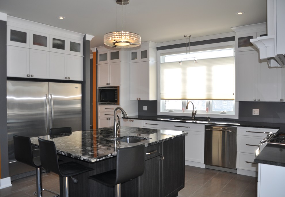 Inspiration for a large transitional l-shaped ceramic tile enclosed kitchen remodel in Ottawa with an undermount sink, shaker cabinets, white cabinets, granite countertops, stainless steel appliances and an island