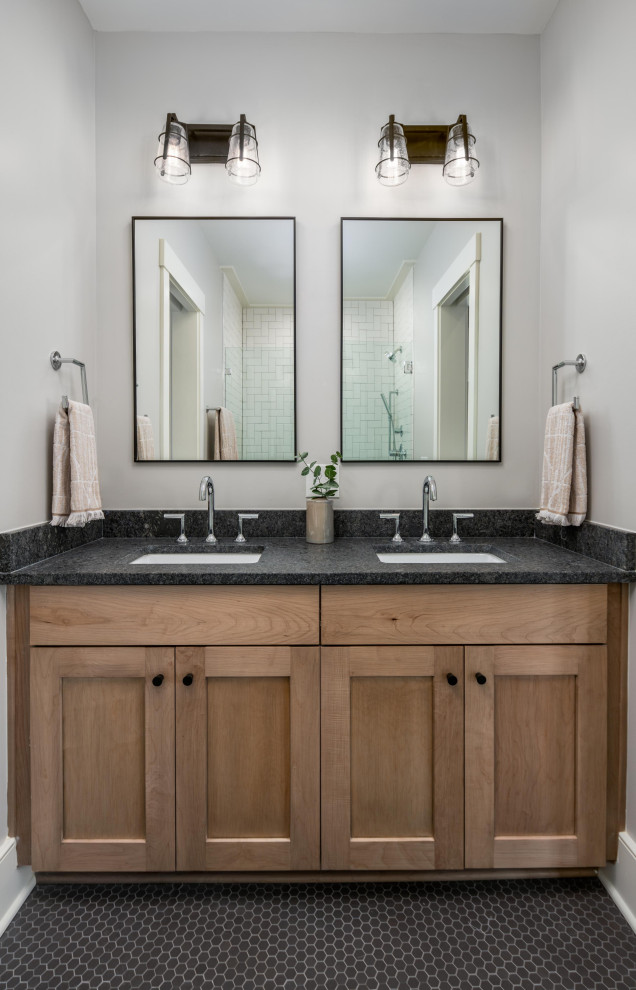 This is an example of a beach style 3/4 bathroom in Charleston with shaker cabinets, light wood cabinets, grey walls, mosaic tile floors, an undermount sink, black floor, black benchtops, a double vanity and a built-in vanity.