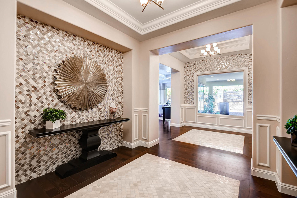 Large transitional foyer in Las Vegas with beige walls, dark hardwood floors and a single front door.