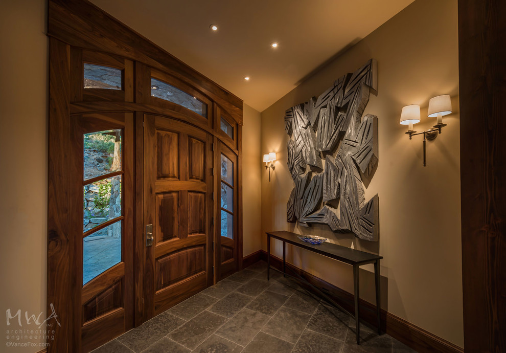 Transitional front door photo with beige walls and a medium wood front door