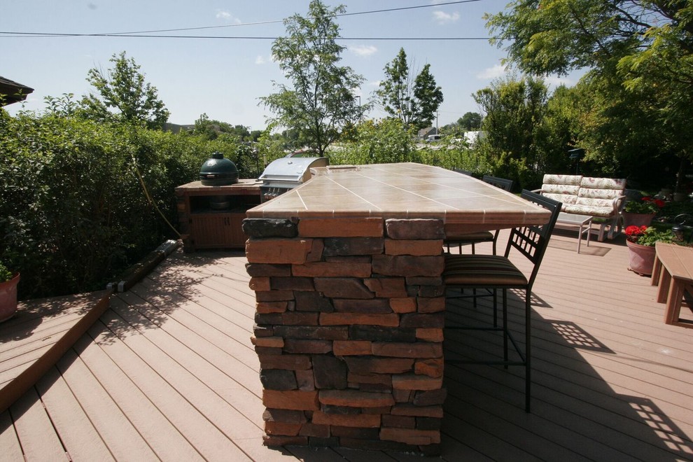 Large mountain style backyard outdoor kitchen deck photo with decking and a gazebo