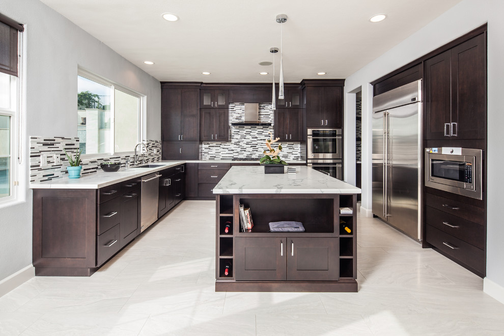 Inspiration for a mid-sized modern u-shaped kitchen in San Diego with an undermount sink, shaker cabinets, dark wood cabinets, marble benchtops, multi-coloured splashback, matchstick tile splashback, stainless steel appliances, porcelain floors and with island.