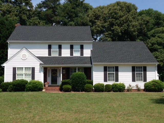 Small elegant white two-story vinyl exterior home photo in Other with a hip roof