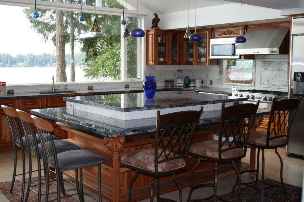 Photo of a large traditional l-shaped eat-in kitchen in Seattle with raised-panel cabinets, medium wood cabinets and with island.