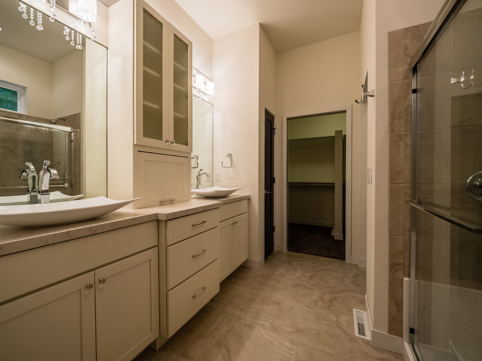 Small contemporary master bathroom in Other with shaker cabinets, white cabinets, a corner shower, white tile, slate, beige walls, medium hardwood floors, a vessel sink, laminate benchtops, brown floor, a sliding shower screen and multi-coloured benchtops.