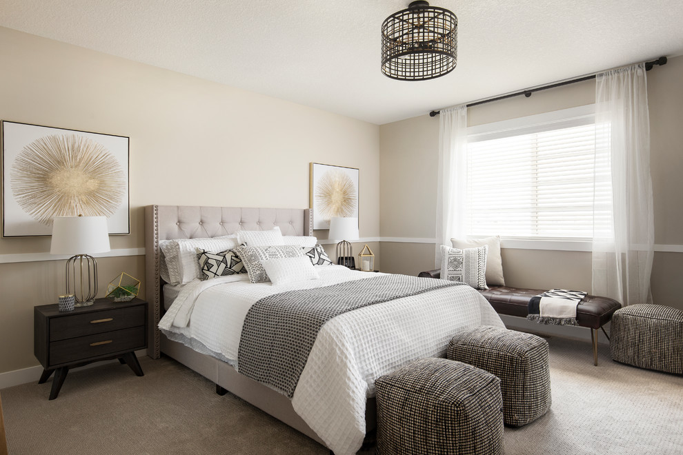 This is an example of a transitional master bedroom in Calgary with beige walls, carpet, no fireplace and grey floor.