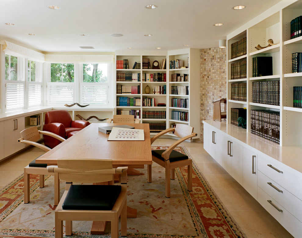 Design ideas for a traditional family room in Boston with white walls and a library.