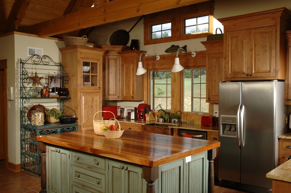 This is an example of a mid-sized traditional u-shaped kitchen in San Diego with a farmhouse sink, raised-panel cabinets, medium wood cabinets, wood benchtops, stainless steel appliances, terra-cotta floors, with island and red floor.