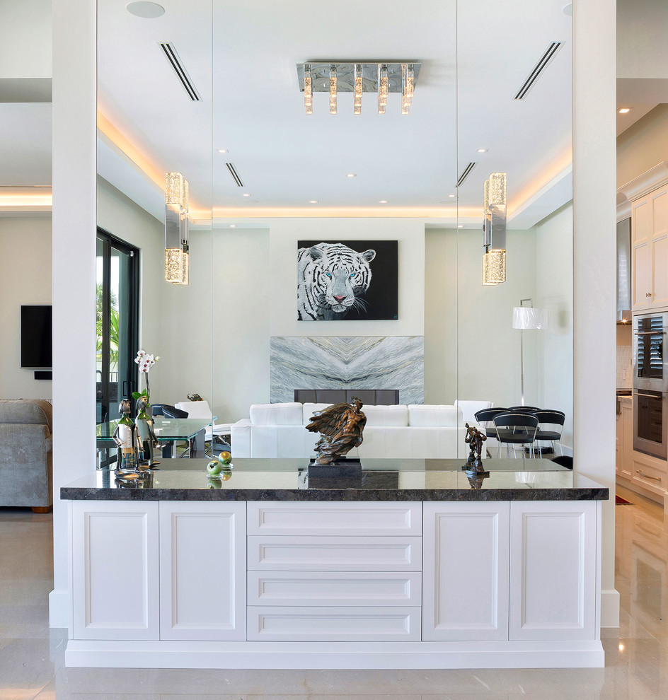 Inspiration for a mid-sized transitional l-shaped ceramic tile and beige floor open concept kitchen remodel in Miami with an undermount sink, recessed-panel cabinets, white cabinets, marble countertops, multicolored backsplash, mosaic tile backsplash, stainless steel appliances, an island and multicolored countertops