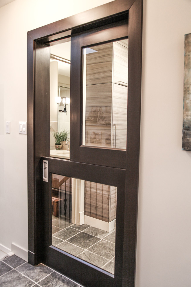 Mid-sized transitional l-shaped slate floor home design photo in Calgary with an utility sink, flat-panel cabinets, gray cabinets, quartz countertops, beige walls and a side-by-side washer/dryer