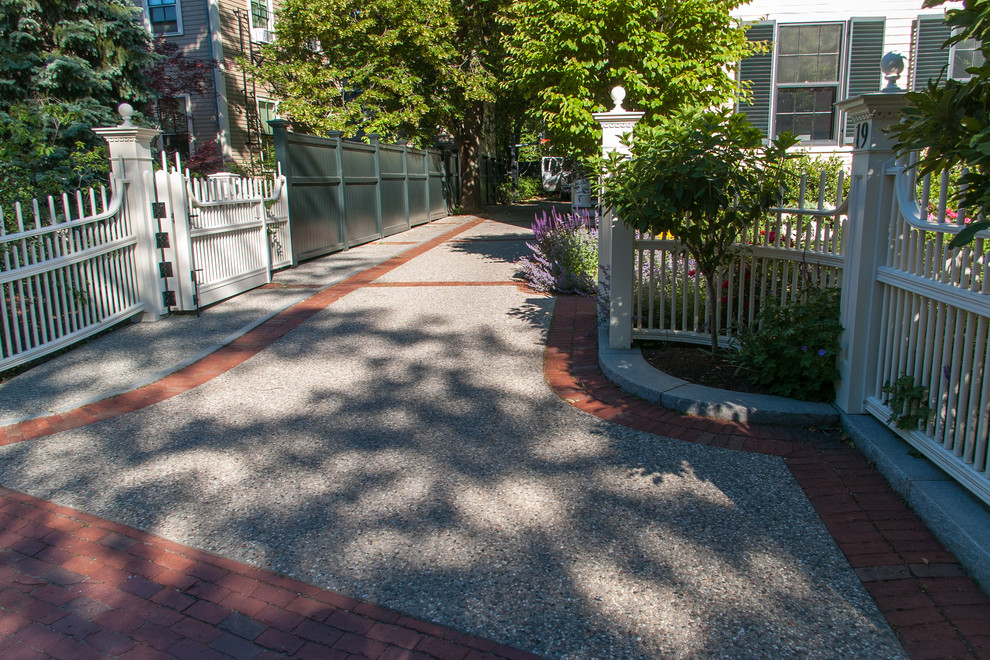 Photo of a mid-sized traditional front yard partial sun driveway in Boston.