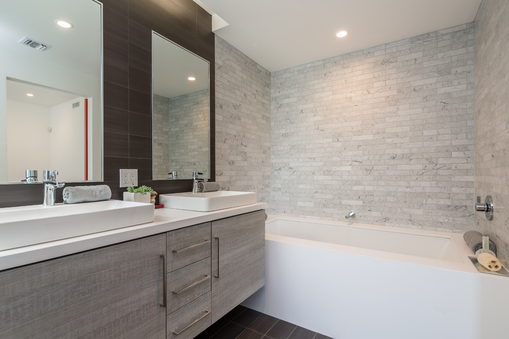 Photo of a mid-sized modern master bathroom in Los Angeles with flat-panel cabinets, light wood cabinets, an undermount tub, an open shower, white tile, marble, multi-coloured walls, porcelain floors, a vessel sink, engineered quartz benchtops, grey floor and a hinged shower door.