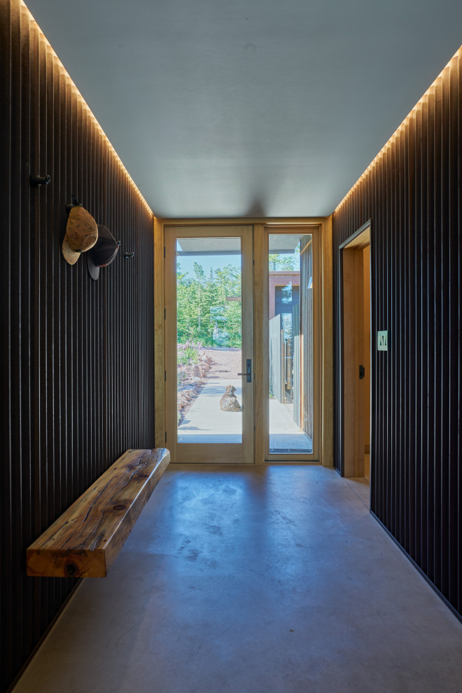 Inspiration for a rustic concrete floor entry hall remodel in Seattle with a glass front door
