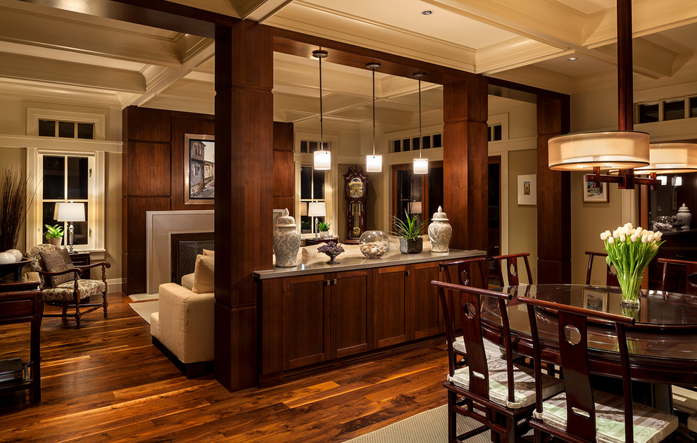 This is an example of a traditional open plan dining in Vancouver with dark hardwood floors.