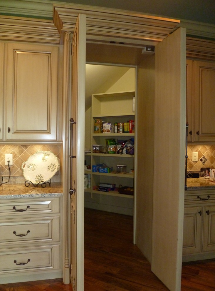 Photo of an arts and crafts kitchen pantry in Atlanta with beige cabinets.