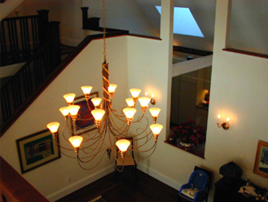 Inspiration for a mid-sized transitional light wood floor hallway remodel in Boston with white walls