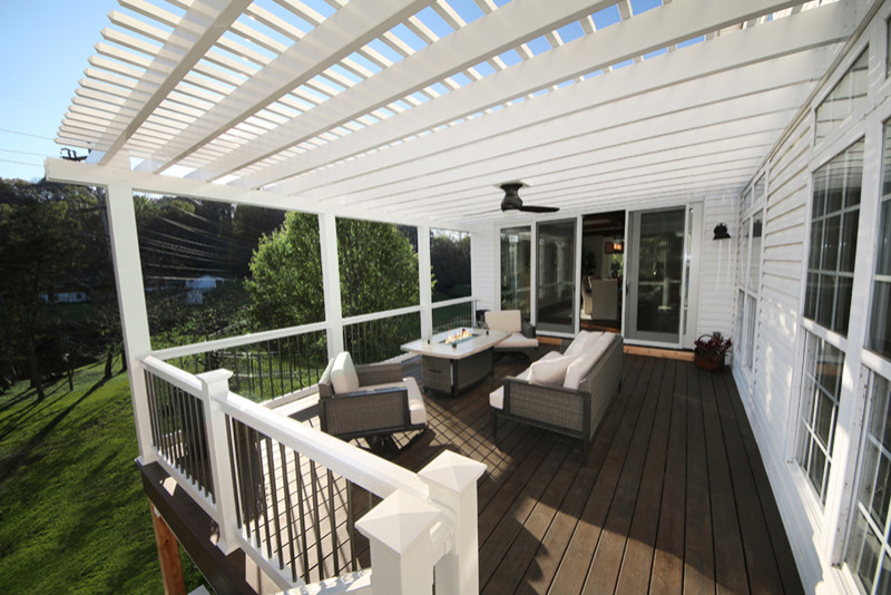 Photo of a large arts and crafts backyard deck in St Louis with with fireplace and an awning.